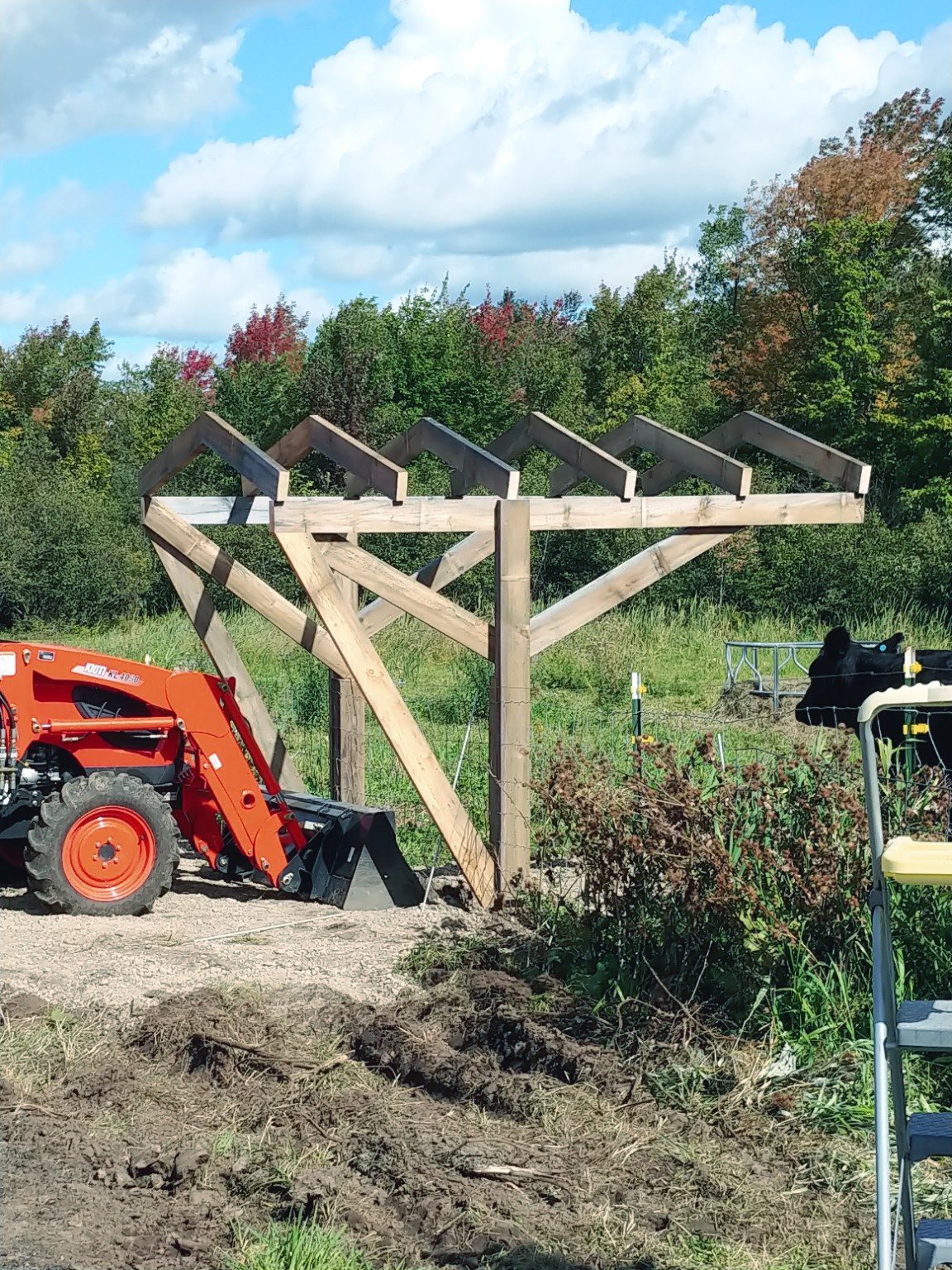 A farm building project with tractor and timber framing